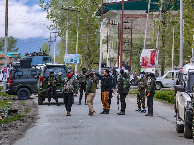 Security personnel stand guard after attack in sopore area in Kashmir