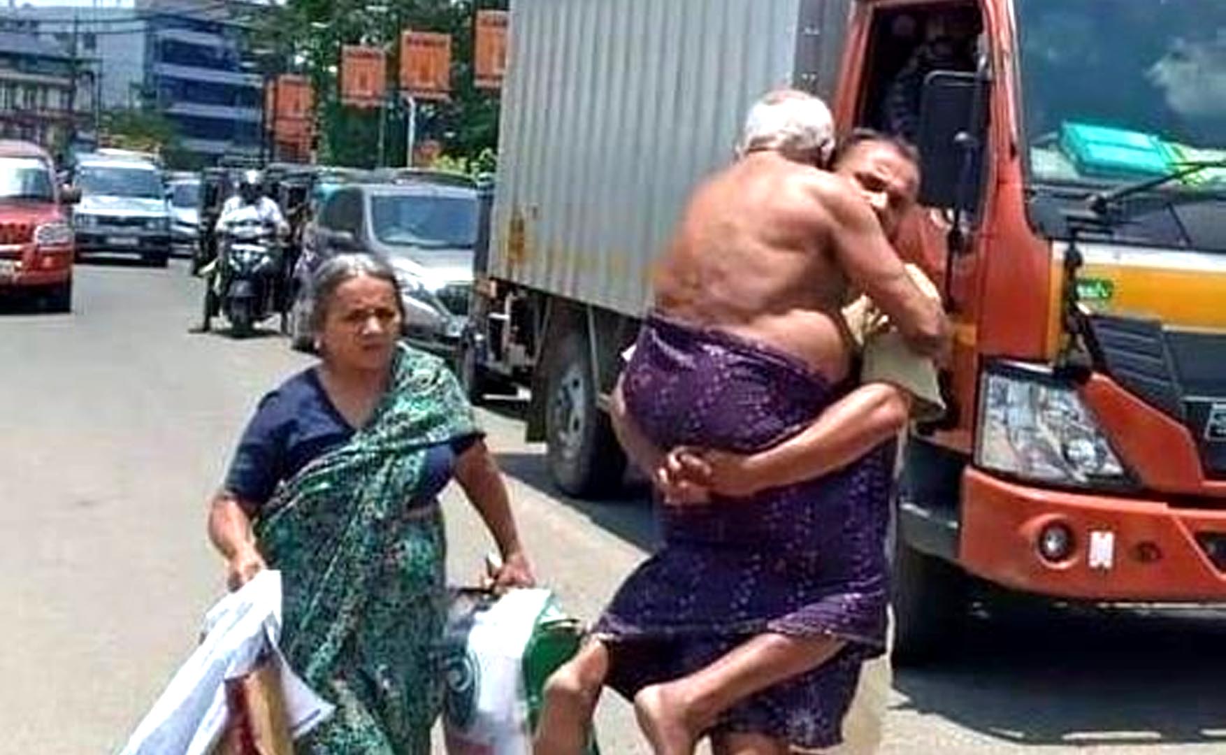 kerala man carries ailing father on shoulders to hospital