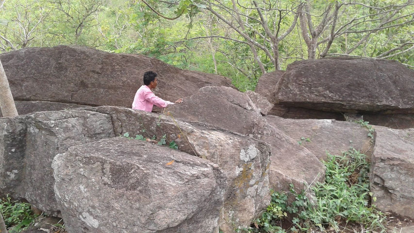 Researcher Anam Behera at the stone age Rock Shelter in Nayagarh District